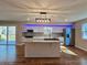 Open concept kitchen with granite countertops, stainless steel appliances, and modern lighting at 621 Hood Rd, Stockbridge, GA 30281