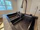 Modern kitchen sink with stainless steel faucet and accessories on a granite countertop at 621 Hood Rd, Stockbridge, GA 30281