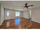 Spacious living room with beautiful hardwood floors, a ceiling fan, and a large window at 621 Hood Rd, Stockbridge, GA 30281
