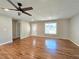 Cozy living room featuring hardwood floors, a ceiling fan, and natural light from the window at 621 Hood Rd, Stockbridge, GA 30281