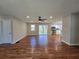 Open-concept living room with hardwood floors, ceiling fan, and view into the modern kitchen at 621 Hood Rd, Stockbridge, GA 30281