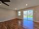 Bright living room with hardwood floors, a ceiling fan, and access to an outdoor deck at 621 Hood Rd, Stockbridge, GA 30281