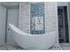 Freestanding bathtub with decorative tile backsplash at 30 Woodbrook Ct, Mcdonough, GA 30252