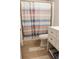 Bathroom featuring a modern white vanity and striped shower curtain at 30 Woodbrook Ct, Mcdonough, GA 30252