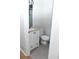 Compact bathroom features a toilet, gray tile floors, a white sink and storage cabinet at 30 Woodbrook Ct, Mcdonough, GA 30252