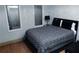Stylish bedroom with hardwood floors, neutral walls, and a comfortable bed with patterned bedding at 30 Woodbrook Ct, Mcdonough, GA 30252