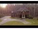 Charming two-story brick home with well-manicured lawn and circular driveway at 30 Woodbrook Ct, Mcdonough, GA 30252