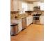 Modern kitchen featuring stainless steel appliances, granite countertops, and custom cabinetry at 30 Woodbrook Ct, Mcdonough, GA 30252