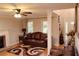 Inviting living room featuring a decorative fireplace, hardwood floors, and a comfortable leather sofa at 30 Woodbrook Ct, Mcdonough, GA 30252