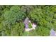 Birds-eye view of a home nestled among trees, with a driveway and green lawn at 950 Ivy St, Cumming, GA 30041
