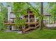A spacious back deck with multiple seating areas is accessible by a staircase at 950 Ivy St, Cumming, GA 30041