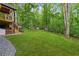 Lush backyard with mature trees and manicured lawn at 950 Ivy St, Cumming, GA 30041