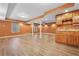 Large basement with wood floors, support pillars, and a functional kitchenette at 950 Ivy St, Cumming, GA 30041
