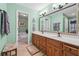 En suite bathroom with double vanity, decorative lighting, and soaking tub at 950 Ivy St, Cumming, GA 30041