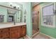Bathroom with a wood vanity and walk-in shower with decorative tile at 950 Ivy St, Cumming, GA 30041