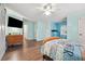 Spacious bedroom featuring a ceiling fan and a mounted flatscreen TV at 950 Ivy St, Cumming, GA 30041