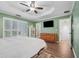 Bedroom featuring bright natural light, tray ceiling, and flatscreen television at 950 Ivy St, Cumming, GA 30041
