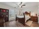 Bedroom features plantation shutters, hardwood flooring, a ceiling fan, and a decorative headboard at 950 Ivy St, Cumming, GA 30041