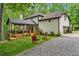 Rear view of the home with multiple decks, backyard, and gravel driveway at 950 Ivy St, Cumming, GA 30041