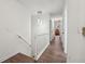 Upstairs hallway with wood floors has natural lighting, and is neutrally painted at 950 Ivy St, Cumming, GA 30041