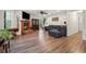 Spacious living room with hardwood floors, a brick fireplace, large windows and an adjacent doorway at 950 Ivy St, Cumming, GA 30041