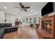 Expansive living room showcases a fireplace, hardwood floors, and access to a bar and exterior patio at 950 Ivy St, Cumming, GA 30041