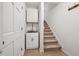 Hallway including a utility sink and carpeted stairs at 950 Ivy St, Cumming, GA 30041