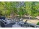 Exterior view of a grey deck area with outdoor seating with a yard and trees in the background at 3107 Sandhurst Dr, Woodstock, GA 30189