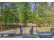 Exterior backyard view from deck area, featuring dense trees and green grass at 3107 Sandhurst Dr, Woodstock, GA 30189