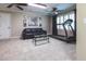 Spacious finished basement featuring a black leather sofa, treadmill, neutral carpet, and ceiling fans at 3107 Sandhurst Dr, Woodstock, GA 30189