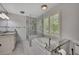 Bathroom with glass enclosed shower, soaking tub, and large bright window at 3107 Sandhurst Dr, Woodstock, GA 30189