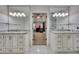 Dual vanity bathroom with white marble countertops and contemporary lighting at 3107 Sandhurst Dr, Woodstock, GA 30189