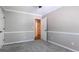Bedroom with carpet, trim and white wainscoting, with view through doorway to hallway at 3107 Sandhurst Dr, Woodstock, GA 30189
