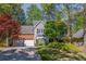 Charming two-story home featuring a brick and gray facade with an attached two-car garage at 3107 Sandhurst Dr, Woodstock, GA 30189