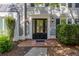 Elegant front door with sidelights, decorative trim, and a brick walkway, adding curb appeal at 3107 Sandhurst Dr, Woodstock, GA 30189