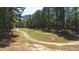 Scenic golf course view with tree-lined fairways and a winding cart path at 3107 Sandhurst Dr, Woodstock, GA 30189