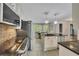 Open kitchen featuring white cabinets, dark countertops, stainless steel appliances, and an island with seating at 3107 Sandhurst Dr, Woodstock, GA 30189