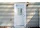 White back door with glass insert, located at the rear of the home, illuminated by an exterior light at 3465 Maple Valley Dr, Cumming, GA 30040