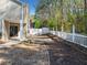Lovely backyard featuring a patio, garden beds, and a white picket fence at 3465 Maple Valley Dr, Cumming, GA 30040