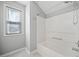 Clean bathroom with white bathtub, chrome fixtures, and white-framed window at 3465 Maple Valley Dr, Cumming, GA 30040