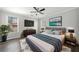 Comfortable bedroom featuring a ceiling fan, bright windows, and a plush rug, perfect for relaxation at 3465 Maple Valley Dr, Cumming, GA 30040