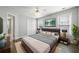 Bedroom features a ceiling fan, two windows, and a queen bed with modern bedding at 3465 Maple Valley Dr, Cumming, GA 30040