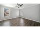 Bedroom with two windows and wood-look floors, featuring neutral walls at 3465 Maple Valley Dr, Cumming, GA 30040