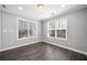 Versatile bonus room with ample natural light from two windows and light gray walls at 3465 Maple Valley Dr, Cumming, GA 30040