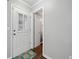 Welcoming entryway with white door, interior white door, and blue accent rug on dark wood floors at 3465 Maple Valley Dr, Cumming, GA 30040