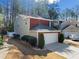 Inviting brick and siding home showcasing a two-car garage, surrounded by mature trees and landscaping at 3465 Maple Valley Dr, Cumming, GA 30040