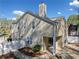 An exterior view of the home showcasing the patio, fenced yard and landscaping at 3465 Maple Valley Dr, Cumming, GA 30040