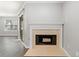 Close-up of a fireplace featuring a decorative mantel, gray walls, and sliding glass door at 3465 Maple Valley Dr, Cumming, GA 30040