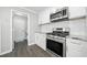 Modern kitchen features white cabinets, stainless steel appliances, and a subway tile backsplash at 3465 Maple Valley Dr, Cumming, GA 30040