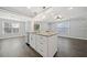 Open kitchen design with granite countertops, a center island, and bright light filled living spaces at 3465 Maple Valley Dr, Cumming, GA 30040